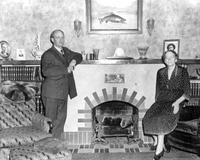 Thumbnail for 'Simon, Dr. & Mrs. John - 1930 (ca.) - In front of the fireplace at their home'