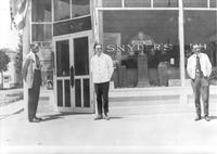 Thumbnail for 'Snyder's Pharmacy - 1920 (ca.) - Outside the Pharmacy with Charley Snyder and two other men'
