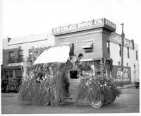 Thumbnail for 'Crysler Drug Co. - 1930 (ca.) - Exterior View with Parade Float'