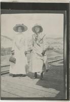 Two women standing on a train platform, after 1904