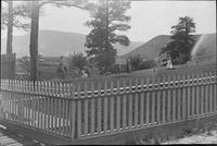 Thumbnail for 'People on Fenced Lawn. Laura - C.M. Williams'