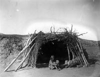 Thumbnail for 'Man Sitting in Front of a Navajo Summer Shelter'