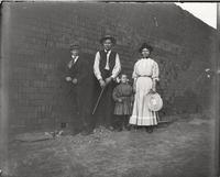 Thumbnail for 'Family Standing in Front of Wall of Bricks'