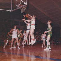 Thumbnail for 'Under-the-basket action in a 1963 game against Adams State College.'