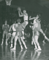 Thumbnail for 'A Mountaineer player gets the rebound in basketball action, mid-1950s.'