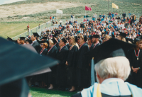 Thumbnail for 'Honor Roll candidates stand as Commencement exercises begin in Mountaineer Bowl, early 1990s.'