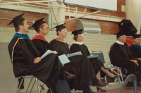 Thumbnail for 'Commencement faculty and speakers are onstage in Wright Gymnasium, early 1990s.'