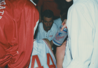 Thumbnail for 'WSC head coach Jay Helman discusses strategy with his team on the sidelines during the 1993 RMAC basketball tournament, March...'