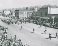 Thumbnail for 'Durango High School marching band marches past Gunnison's West Theater during the 1956 WSC Band Day parade.'