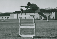 Thumbnail for 'A WSC hurdler practices on the field south of Mountaineer Gymnasium, ca. early 1960s.'