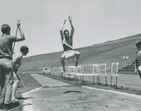 Thumbnail for 'A WSC long jump competitor is caught in mid-air in this photograph of Mountaineer Bowl track meet'