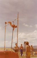 Thumbnail for 'A WSC pole vaulter attempts to clear the bar in 1977 track and field action in Mountaineer Bowl.'