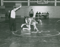 Thumbnail for 'A WSC wrestler scores two points in Mountaineer Gymnasium wrestling action, ca. 1961.'