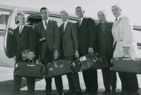 Thumbnail for 'Part of the 1963 WSC wrestling team pose for a photograph before boarding a charter flight to Cedar Falls, Iowa, where the team...'