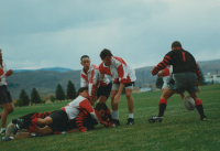 Thumbnail for 'Someone's flick pass didn't go so well in WSC Rugby Club action at the practice field north of Wright Gymnasium, ca. 2000s.'