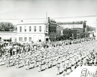 Thumbnail for 'The WSC Mountaineer Marching Band on parade, Main Street, Gunnison ca. 1956.'