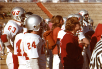 Thumbnail for 'Mountaineer team members watch the action from the sidelines in the 1978 football playoff game in San Angelo, Texas, December...'