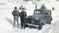 Thumbnail for 'Two Hiking and Outing Club members pose in front of their vehicle, circa 1935.'