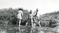 Thumbnail for 'Mrs. John C. Johnson and others wading in an unknown stream, circa 1915.'
