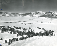 Thumbnail for 'Spectators gather at the foot of Rozman Hill to watch an intercollegiate ski jumping contest, ca. early to mid-1950s.'