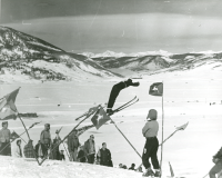 Thumbnail for 'Spectators watch a ski jumping competition at Rozman Hill, 1950s.   The southern end of Crested Butte mountain can be seen in...'