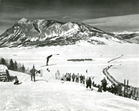 Thumbnail for 'Spectators watch a ski jumping competition at Rozman Hill, 1950s.  Excellent view of Crested Butte mountain in the background.'