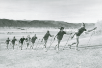 Thumbnail for 'Eight WSC ski team members on a dry training run on the lower slopes of Cupola Hill, ca. early 1980s.'