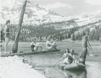 Thumbnail for 'A group of five WSC coeds boating and sunbathing in a late spring promotional photograph at Lake Irwin, 1940.'