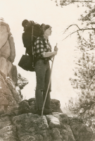 Thumbnail for 'A lone Western coed looks out from a rock ledge while mountain climbing, circa early 1970s.'