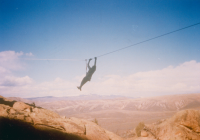 Thumbnail for 'A WSC Mountaineer Rescue team member moves hand-over-hand along a line.  1994.'