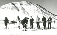Thumbnail for 'A men's ski class watches their instructor in cross country skiing, ca. 1950s'