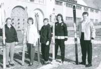 Thumbnail for 'Five female alpine skiers (ski team members?) pose in front of Mountaineer Gymnasium, ca. 1954.'