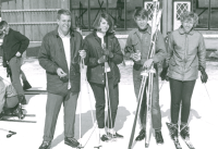 Thumbnail for 'A group of WSC students pose in front of the warming house, ca. mid-1960s. Note the lace-up boots and safety straps for the...'