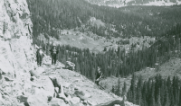 Thumbnail for 'Hiking and Outing Club members pause on the shelf road below the Alpine Tunnel, circa early 1950s.'