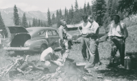 Thumbnail for 'Hiking and Outing Club members around gather around a campfire, circa 1950.'