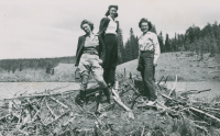 Thumbnail for 'Three Hiking and Outing Club members pose on top of a beaver lodge, circa late 1940s.'