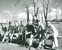 Thumbnail for 'Members from a late-1950s WSC baseball team, rakes in hand, take a break from preparing the field for practice.'