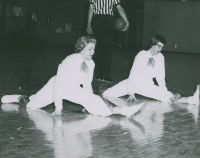 Thumbnail for 'Two Western cheerleaders do the splits, circa mid-1950s.'