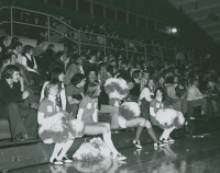Thumbnail for 'Western cheerleaders on the bleachers during a Wright Gymnasium event, 1970s.'