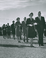 Thumbnail for 'The 1962 Homecoming Queen Mary Ellen Reynolds and her attendants are escorted into Mountaineer Bowl by WSC President Harlan...'