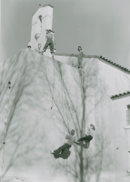 Thumbnail for 'WSC coeds rappell down the southwest wall of the old Savage Library, ca. late 1940s, while fellow students look on.'