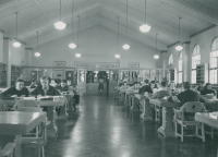 Thumbnail for 'Interior view of Leslie J. Savage Library looking west toward the original circulation desk, circa early 1950s.'