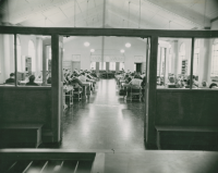Thumbnail for 'Interior of Leslie J. Savage Library ca. early 1950s. View is from the circulation desk/main entrance area to the east end of the...'