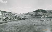 Thumbnail for 'The Westernfootball team in action from the north end of Mountaineer Bowl, early 1950s.'