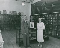 Thumbnail for 'Botany professor Dr. Ralph Walker and Mrs. Clarence Hurst pose in Taylor Hall's Hurst Museum, 1950s.'