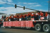 Thumbnail for 'The WSC Varsity Band rides on a flatbed trailer in the 2001 Homecoming parade on Main Street.'