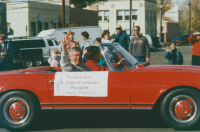 Thumbnail for 'WSC President Harry Peterson waves to the camera during the 2001 Homecoming parade on Main Street.'