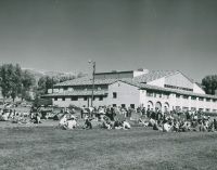 Thumbnail for 'A picnic is enjoyed by the campus community southwest of Mountaineer Gymnasium (Wright Gymnasium) in 1955.'