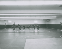 Thumbnail for 'A wrestling class is in session in Mountaineer Gymnasium, circa early 1960s.'