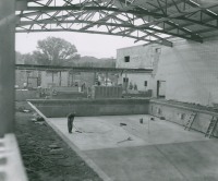 Thumbnail for 'The new swimming pool in the gymnasium addition is under construction, circa 1959.'
